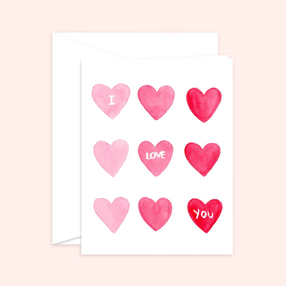 Watercolor greeting card featuring a grid of nine pink and red hearts, with the words "I Love You" scattered across three of them.