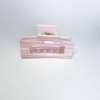 Thumbnail for 
A pearlescent, light pink hair claw clip with a visible metal spring is shown head-on against a white background.