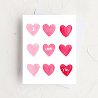 Thumbnail for A watercolor card with a grid of nine pink and red hearts reading 