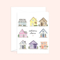 Thumbnail for Watercolor greeting card and white envelope featuring a grid of eight unique, colorful houses surrounding the handwritten words 