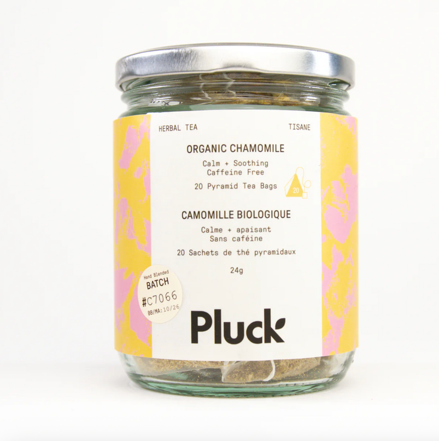 A jar of Pluck Organic Chamomile tea bags with a patterned label in English and French. The label mentions "20 Pyramid Tea Bags."