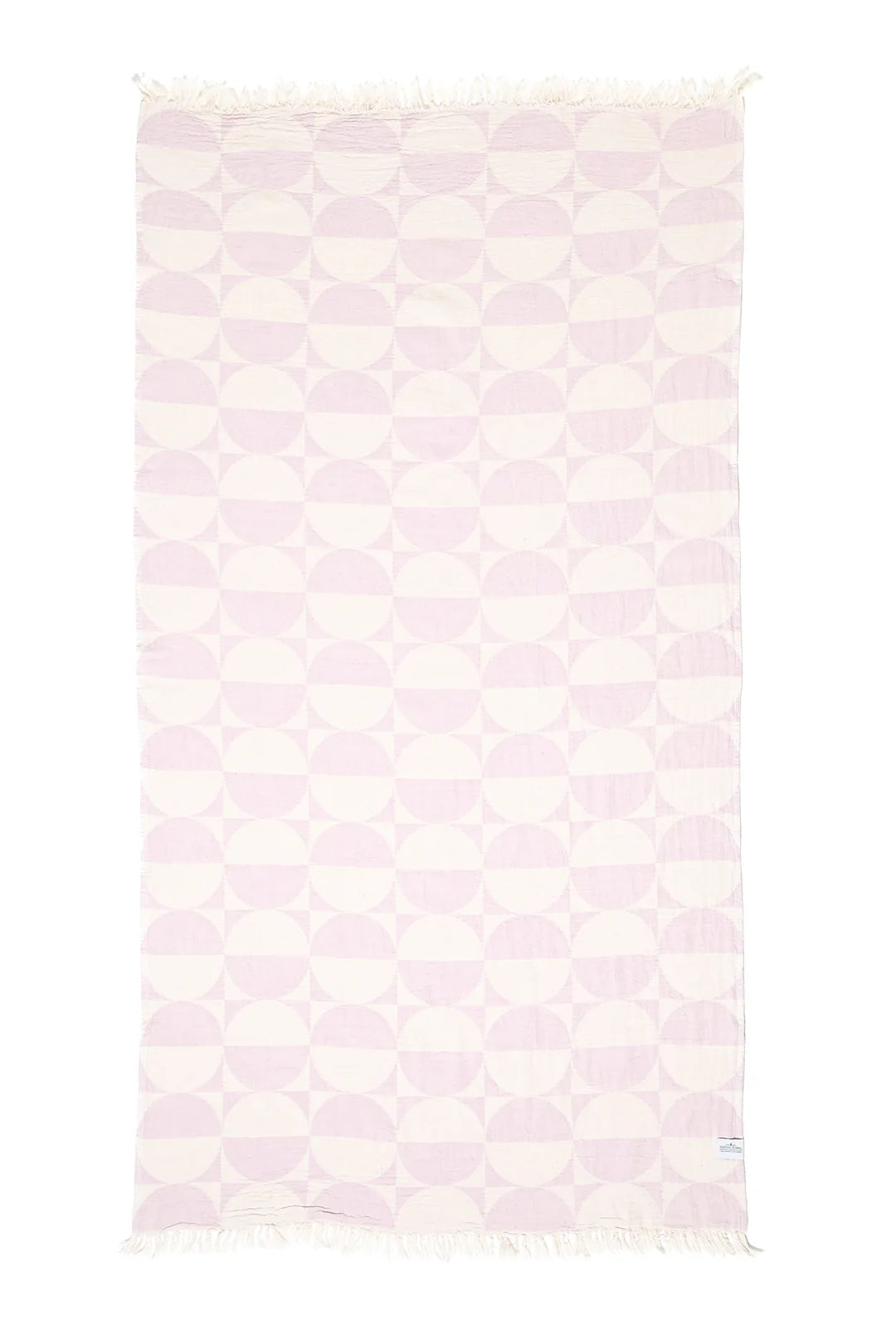 A vertical flat lay of the Phase towel in Lilac against a white background. The geometric design consists of repeating rows of lavender half-circles on an off-white base, with matching tassels on the top and bottom edges.