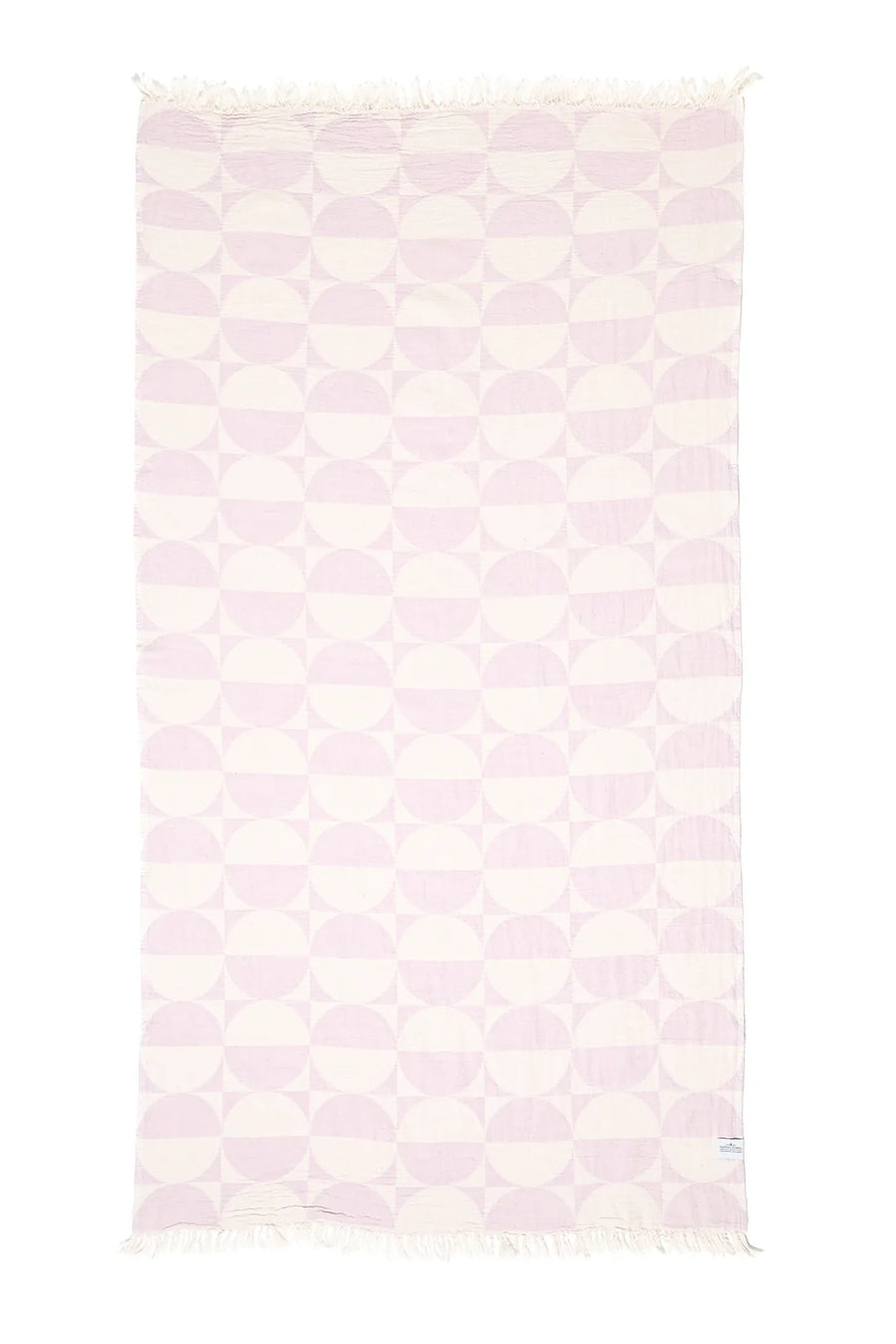A vertical flat lay of the Phase towel in Lilac against a white background. The geometric design consists of repeating rows of lavender half-circles on an off-white base, with matching tassels on the top and bottom edges.