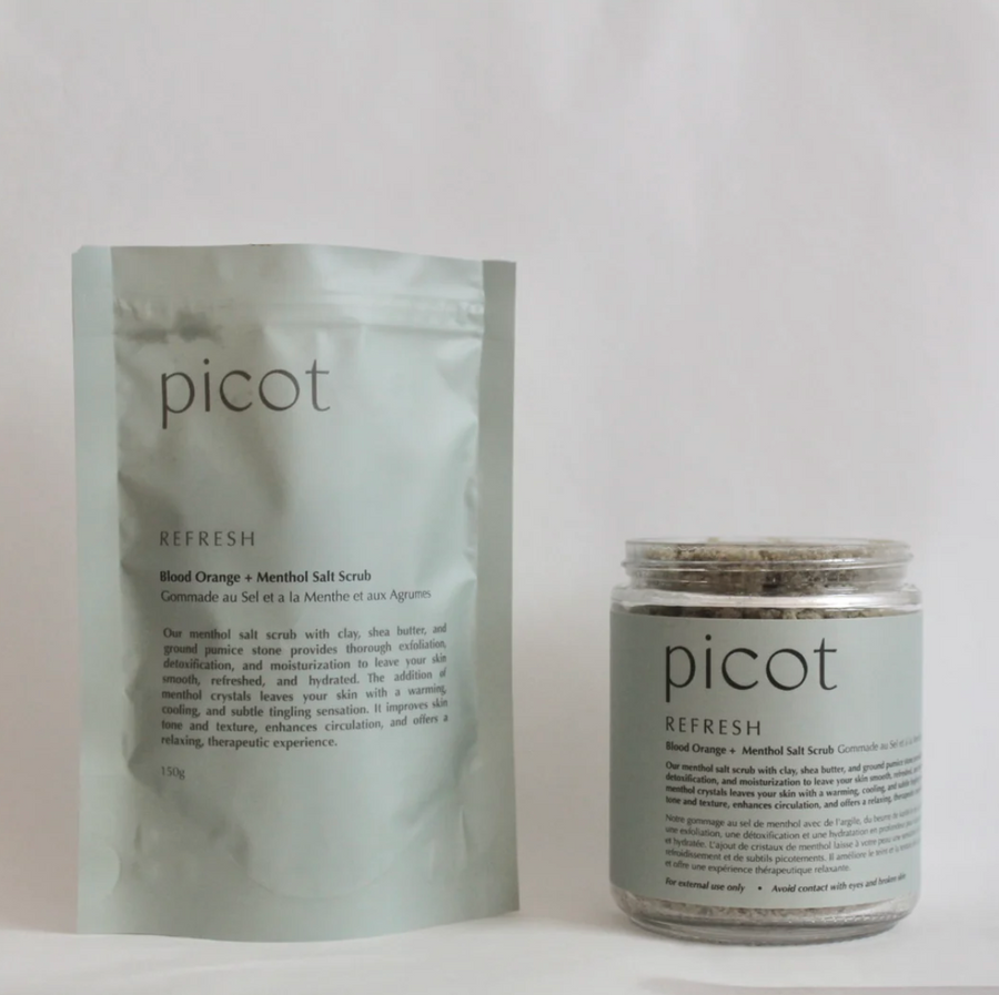 A light green pouch and a glass jar, both labeled "picot refresh Blood Orange + Menthol Salt Scrub," are placed side by side on a white background.