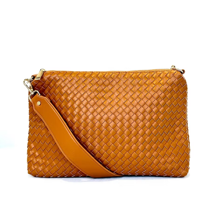 A tan, woven vegan leather crossbody bag is displayed against a white background. It features a matching tan shoulder strap and gold zippers.
