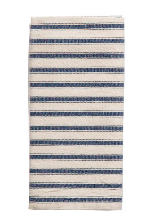 
A neatly folded rectangular kitchen towel with horizontal stripes. The towel is off-white or cream-colored with thick, dark blue stripes and a thinner blue strip on either side of the tick stripes running across its width. The texture is 100% Turkish Cotton.