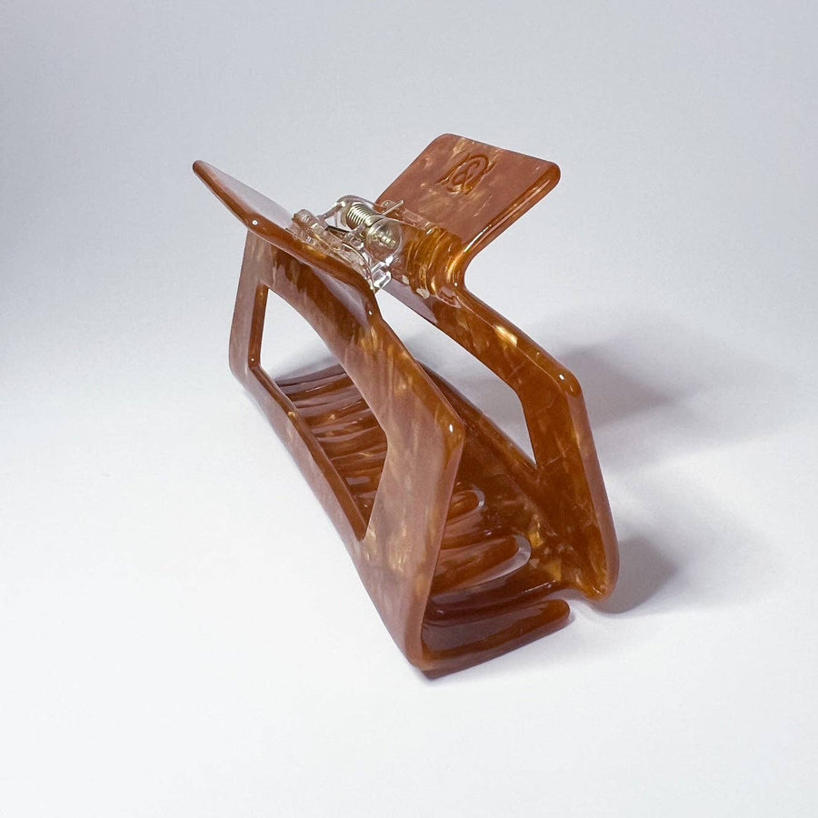 Caramel Brown hair clip on a white background