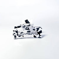 Thumbnail for A large black and white marbled hair claw clip is presented against a white background.
